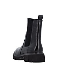 Black leather ankle boot with elastic side panels, a pull tab, and a textured rubber sole. Features a smooth finish and athletic silhouette.