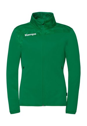Veste verte à fermeture éclair complète avec col montant, manches longues, poches latérales, panneaux d'épaule à motif discret et logo "Kempa" sur la poitrine gauche.