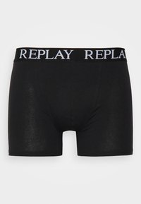 Sorte boksershorts laget av mykt stoff, med en bred elastisk midjebånd med "REPLAY"-logo i hvitt. Glatt tekstur med en tettsittende design.
