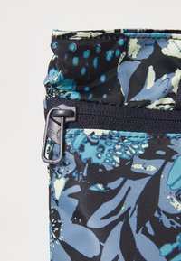 Zippered pouch featuring a colorful floral pattern with shades of blue and black; made of textured fabric with a durable finish.