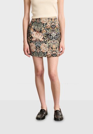 Floral pattern skirt in dark tones with pink, green, and gold accents. Fabric has a textured weave; above-knee length; fitted design.