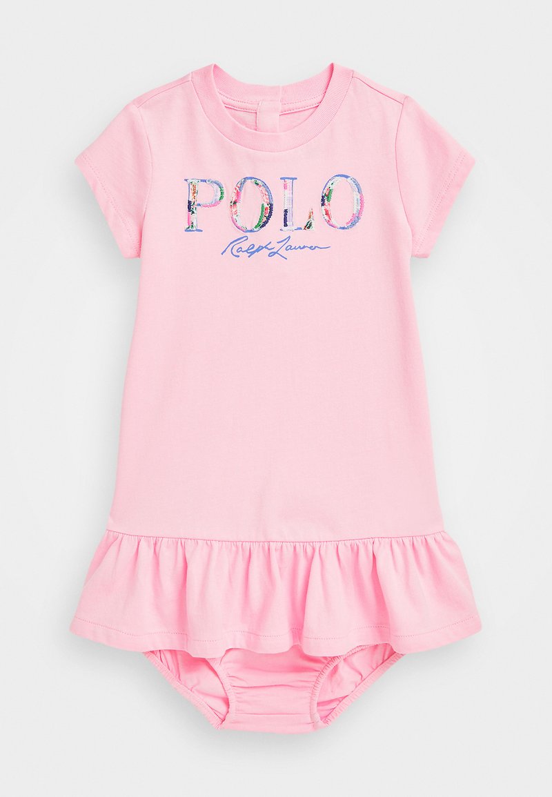 Pink cotton dress with short sleeves, ruffled hem, and "POLO Ralph Lauren" graphic in multicolored floral design. Soft texture and fitted style.