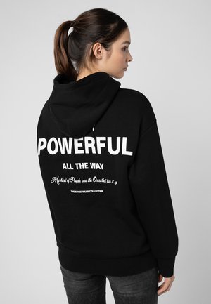 Black hoodie with a large white text on the back: “POWERFUL ALL THE WAY,” featuring additional text below. Soft fabric, casual fit.