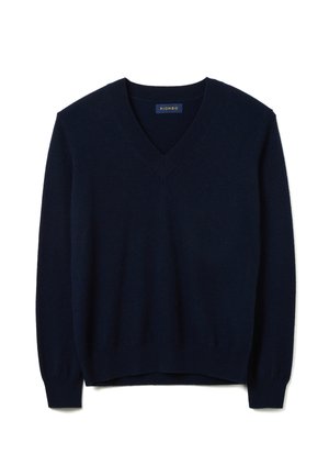 Pull en maille douce bleu marine avec col en V, manches longues et poignets côtelés avec une légère brillance. Étiquette de la marque visible.