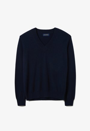 Pull en maille douce bleu marine avec col en V, manches longues et poignets côtelés avec une légère brillance. Étiquette de la marque visible.