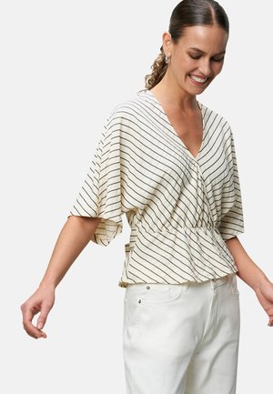 Cream blouse with black horizontal stripes, short sleeves, V-neck, and elastic waist gathered design. Paired with white pants.