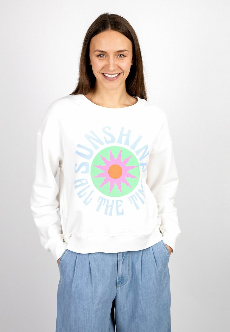 White sweatshirt featuring a colorful sun graphic with a pink outline and green background. Designed with a round neckline and loose fit.