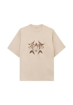 T-shirt beige a maniche corte con un motivo grafico metallico a forma di stella che ricorda le lettere "GCDS" al centro del petto.