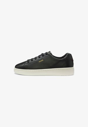 Black leather low-top sneaker with black laces, white sole, and gold "HUGO" logo on side.