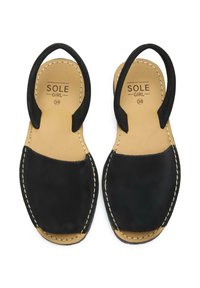 Black leather sandals with a stitched design, open toe, and a back strap. Sole features a tan, textured footbed. Size indicated as 38.