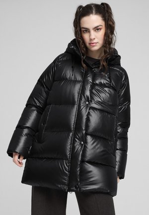 Schwarze Puffjacke mit glänzender Oberfläche, übergroßem Design, hohem Kragen, Fronttaschen und Druckknopfverschlüssen. Texturierte Polsterung überall.