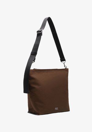 Brown fabric shoulder bag with a rectangular shape, adjustable black strap, metal hardware, and a zip closure. Brand logo visible.