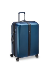 Valise rigide bleue avec une finition texturée, accents de fermeture éclair noirs, poignée rétractable et quatre roues pour une mobilité facile.