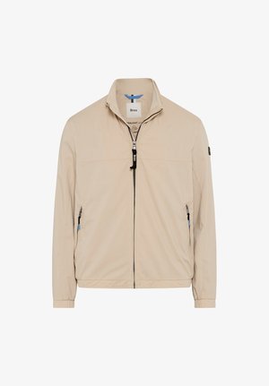 Beige lightweight jacket with high collar, full front zipper, two zippered side pockets, elastic cuffs, brand tag inside collar.