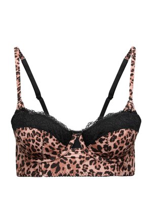 Kvinde iført sort blondelingeri og BH med leopardprint-stropper, vist bagfra mod en ensfarvet baggrund.