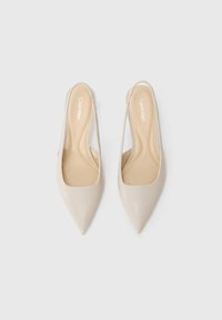 Beezid slingback kontsad jämeda tootega ja siledast materjalist. Omab kergelt pehmendatud tallat ja reljeefset logo.