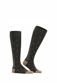 Schwarze knielange Socken mit beigefarbenen Punkten, mit einem einfarbigen beigen Akzent an Zehen und Ferse, gefertigt aus einem weichen, dehnbaren Material.