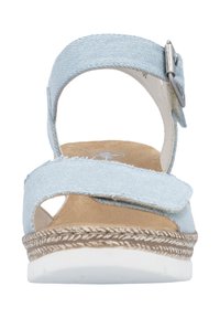 Light blue denim sandals with cross straps, featuring a tan insole, white rubber outsole, and a silver buckle detail on the ankle strap.
