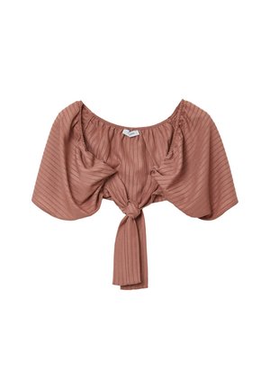 Top court en tissu côtelé couleur rouille avec des manches courtes bouffantes et un nœud devant, sur fond blanc.