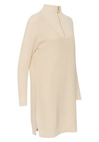Robe-pull tricotée de couleur crème, à manches longues, col montant et demi-fermeture éclair dorée, présentant un motif texturé.