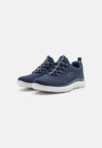 Navy blue athletic shoes with a mesh upper, lightweight design, integrated laces, and a white midsole. Features a green logo accent.