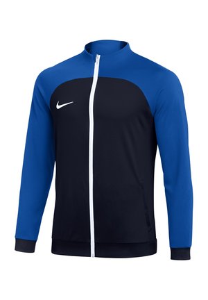 Długorękawowa czarno-niebieska sportowa kurtka z białym zamkiem błyskawicznym z przodu i białym logo Nike Swoosh na piersi.
