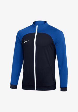 Giacca sportiva nera e blu a maniche lunghe con cerniera frontale bianca e logo Nike bianco sul petto.
