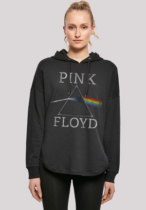 Black hoodie featuring a graphic design with a prism and rainbow, text "PINK FLOYD" in gray, drawstrings at the neck, relaxed fit.