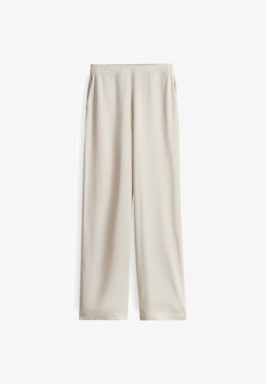 Helle beige weite Hosen aus glatter Stoffqualität, mit elastischem Bund und ohne sichtbare Taschen, in gerader Silhouette.