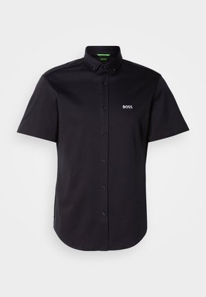 Chemise noire à manches courtes en coton, avec un col boutonné, un logo subtil sur la poitrine et un design classique à ourlet droit.