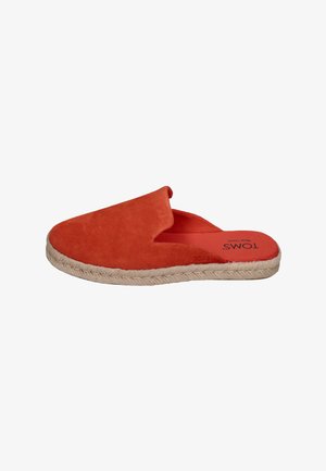 Red suede slip-on mule with beige woven sole and "TOMS Wear Good" printed on the insole, viewed from the side.