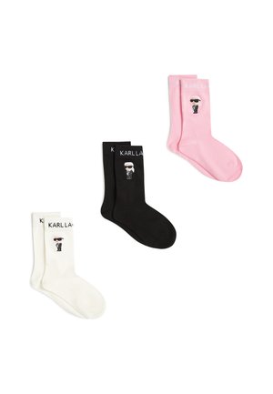 Drei Paar Socken in Weiß, Schwarz und Pink, jeweils mit einer kleinen Cartoon-Figur und dem Text "KARLLA" nahe dem oberen Rand.