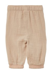 Lichtbeige, los geweven kinderbroek met een elastische tailleband en gathering aan de boorden. De stof heeft een zachte, gestructureerde afwerking.