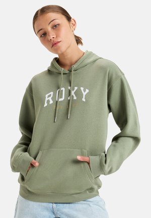 Green hoodie with a kangaroo pocket and drawstring hood. Features "ROXY" logo in white and established date in gold. Soft cotton material.
