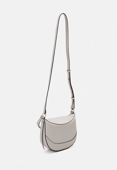 Gray crossbody bag with a curved design, featuring black piping accents and a thin adjustable strap; smooth texture and minimalistic style.