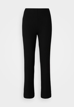 Black ribbed knit pants with a stretchy waistband, featuring a fitted silhouette, straight legs, and subtle texture.