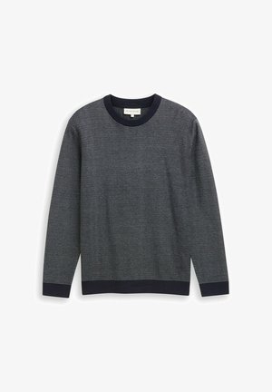 Pull en tricot bleu marine avec un motif texturé, col rond, et des bords côtes contrastants aux poignets et à l'ourlet. Manches longues, coupe regular.