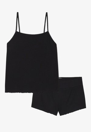 Black ribbed camisole with thin adjustable straps and matching black shorts. Both pieces have a scalloped hem. Soft, stretchable fabric.