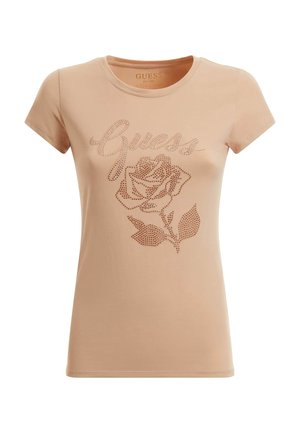 Světle broskvová tričko s krátkým rukávem s vyšívaným designem růže posetou rhinestony a textem "Guess" v kurzívě. Hladký bavlněný materiál.