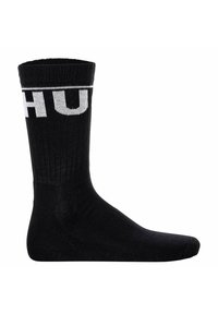 Sort bomuldsstrømpe med ribbet tekstur, der har et hvidt "HUF" logo øverst. Crew længde med forstærket hæl og tå.