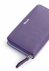 Purple leather wallet with a textured finish, silver zip closure, and a small leather pull tab. Includes a logo embossed on the front.