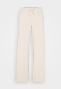 Beige sweatpants with a drawstring waist, wide legs, and a small white logo. Soft fabric with a smooth texture and no visible patterns.