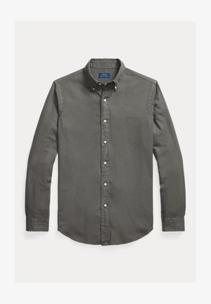 Mørkegrå langermet skjorte med knapper og klassisk krage, som har hvite knapper og en liten brodert logo på brystet. Laget av bomull.