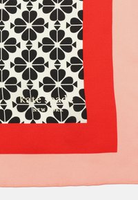 Silky scarf featuring a central black and white floral pattern, bordered by solid red and soft pink edges. Logo in gold at the bottom.