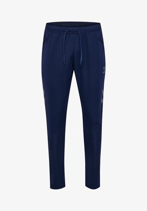 Marineblauwe sportbroek met taps toelopende pijpen, elastische tailleband, trekkoord, zijritstasken en klein reflecterend logo op het bovenbeen.