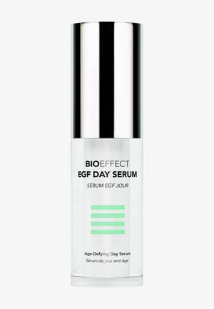 Clear bottle of BIOEFFECT EGF Day Serum with silver cap and green-striped label, labeled as age-defying day serum in English and French.