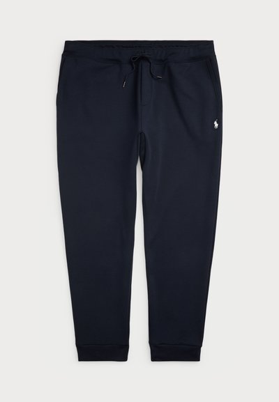 Navy blue sweatpants made of soft cotton blend. Features an elastic waistband with drawstring, cuffed ankle hems, and a small logo detail.