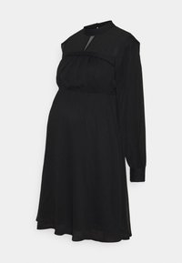Robe de maternité noire à manches longues avec col montant, empiècement transparent, poitrine froncée et jupe évasée en ligne A.