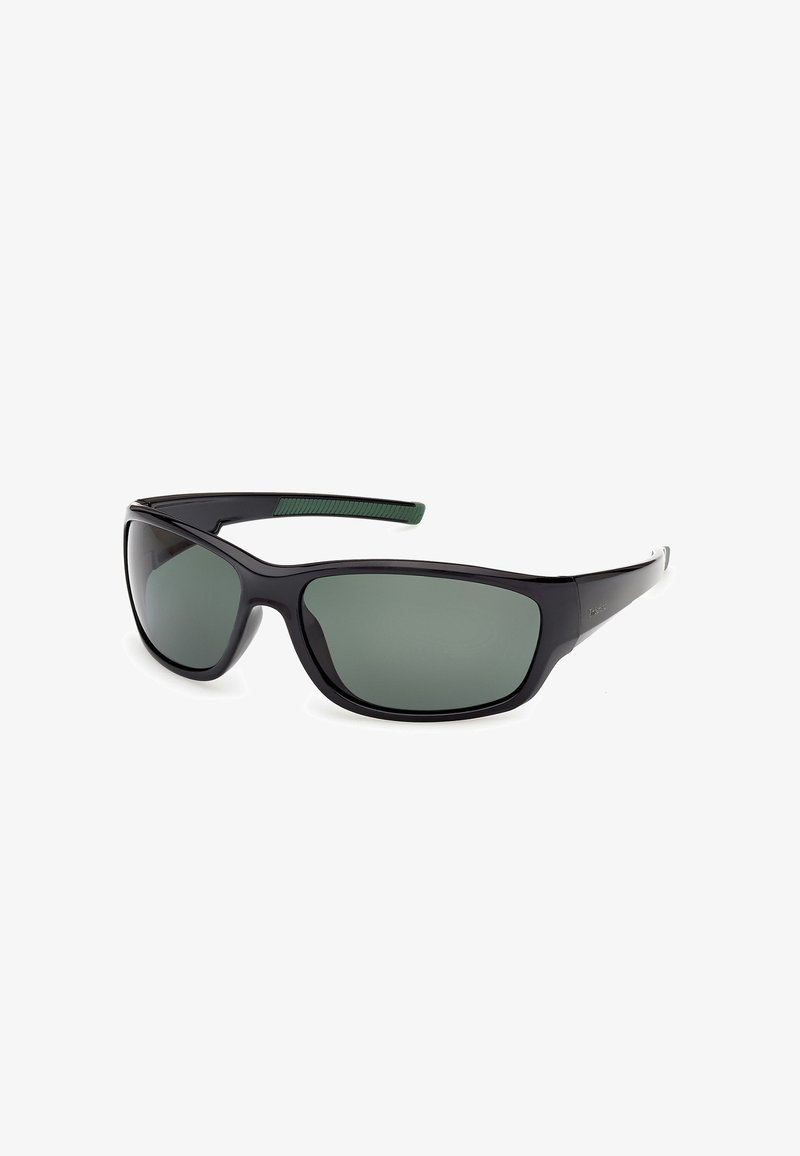 Lunettes de soleil enveloppantes noires avec des verres vert foncé et une prise texturée verte à l'intérieur des branches.