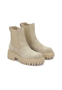 Bottes Chelsea en daim beige avec semelles en caoutchouc épaisses et panneaux latéraux élastiques, présentées côte à côte sur un fond blanc.